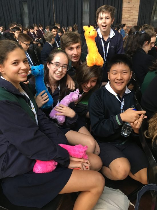 Group of students as spectators each with a soft toy on their lap